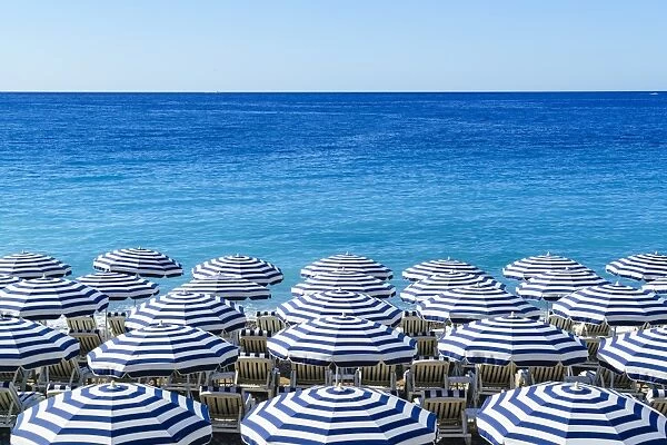 Blue and white beach parasols, Nice, Alpes Maritimes, Cote d Azur, Provence, France
