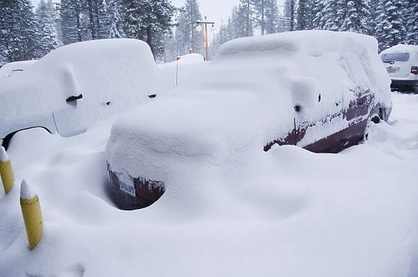 Cars under heavy snow fall at the winter ski resort