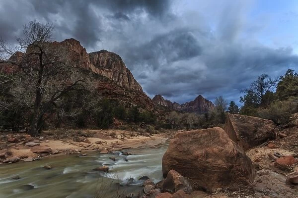 Dusk beside the Virgin River under a threatening sky in winter, Zion National Park, Utah, United States of America, North America