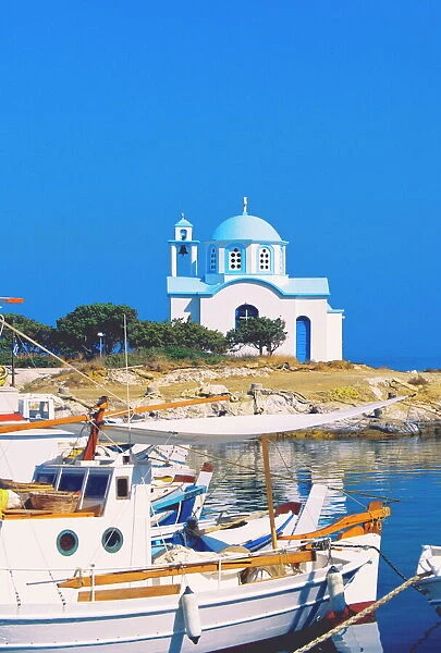 Fishing boats with a chapel in background, Chios Island, Greek Islands, Greece, Europe