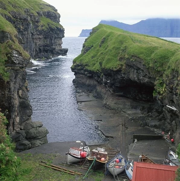Fishing boats in a cove at Gjogv, Estoroy Island, Faroe Islands, Denmark, Europe