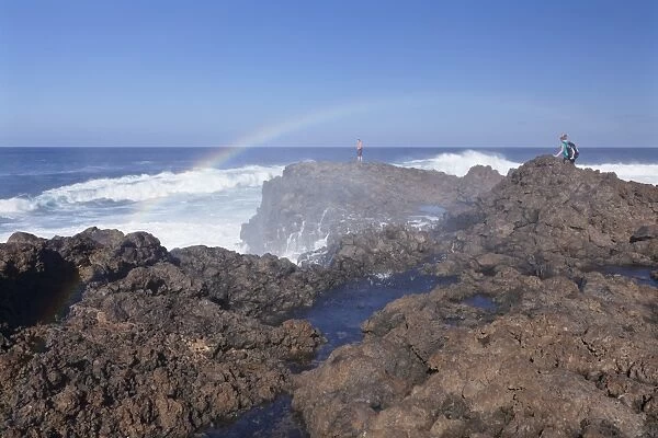 Tourists watching waves at the coast of La Fajana, Barlovento, Canary Islands, Spain