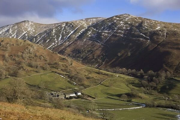 View from Kirkstone Pass showing traditional whitewashed stone farmhouse dwarfed by nearby fells
