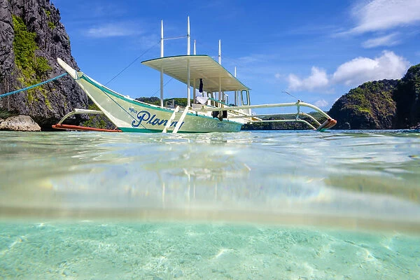 Outrigger boat anchored at Talisay Beach, Tapiutan Island, El Nido, Palawan, Philippines