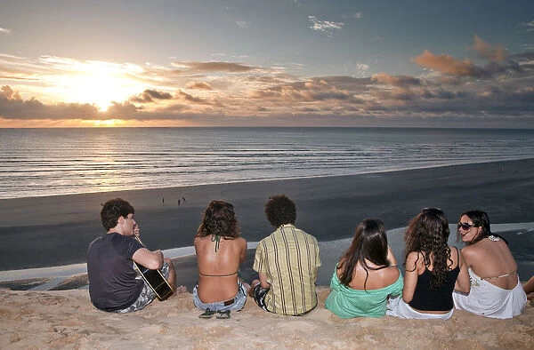 South America, Brazil, Ceara, Jericoacoara, a guitarist and a group of girls watch