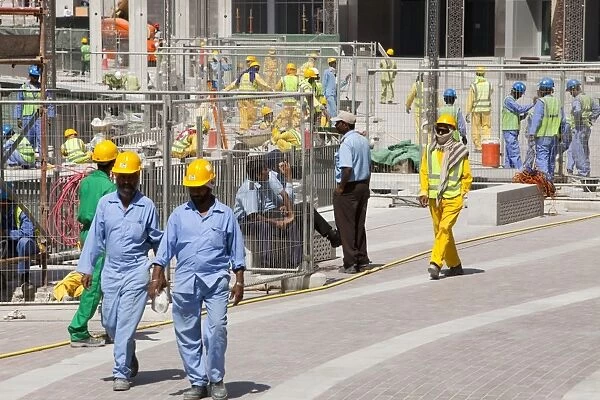 Construction workers working near the Burj Dubai in Dubai