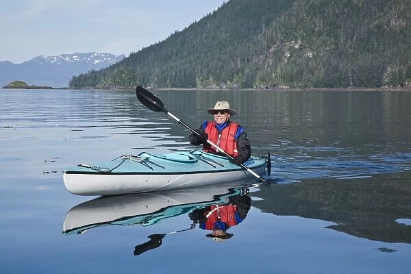 Kayaking in Windham Bay in Southeast Alaska, USA. Pacific Ocean. Kayak property release is DB051905. No model release