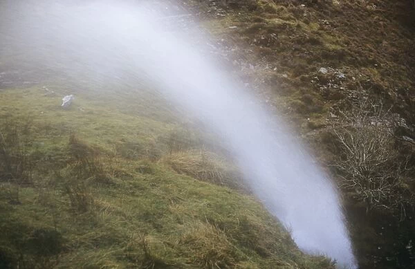 A waterfall being blown back up hill by gale force winds above Bassenthwaite, Lake district, UK