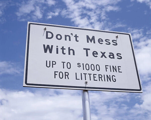 10019539. USA Texas General Sign reading Dont Mess with Texas with light cloud