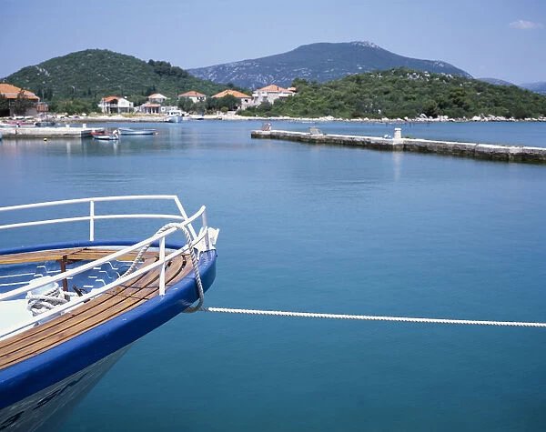 20038517. CROATIA Dalmatia Ston Prow of a moored boat with coastline beyond