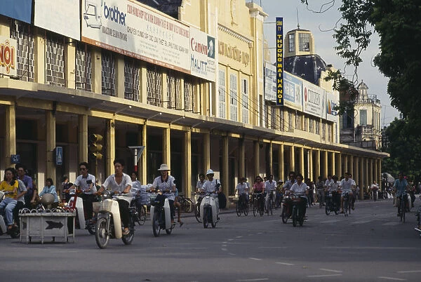 20043747. VIETNAM North Hanoi Mopeds in a street lined with colonnaded buildings