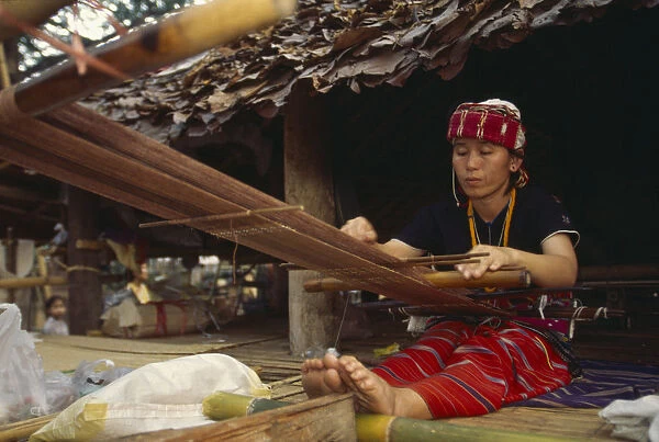 20063639. THAILAND Chiang Mai Sgaw Karen woman weaving cloth on a back strap loom