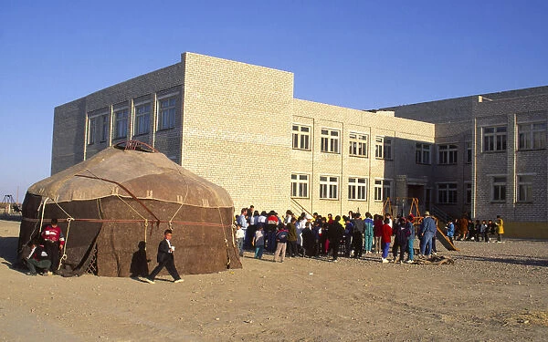 20069005. KAZAKHSTAN Kyzlorda Yourt in Kazakh playground with children and school behind