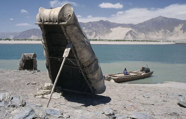 20079533. CHINA Tibet Near Tsetang. Yak skin boats one propped up by a paddle