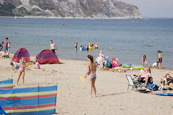 20083451. ENGLAND Dorset Swanage Bay Sandy beach with girls playing Bat
