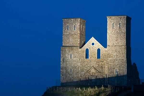 12th Century ruined church illuminated at twilight, St. Marys Church, Reculver Country Park, Reculver, Kent, England
