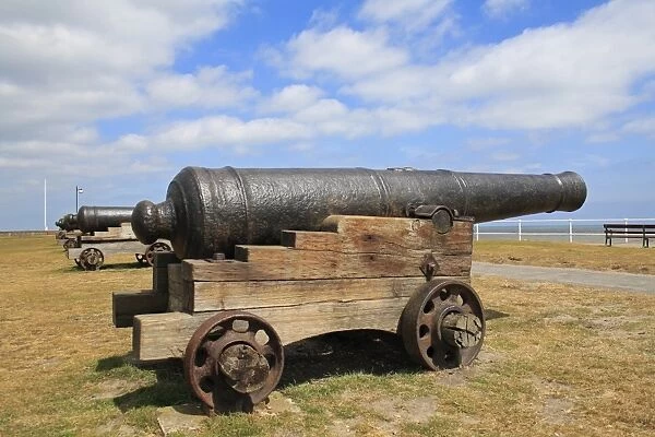 18th Century 18-pounder guns on seafront of seaside town, Gun Hill, Southwold, Suffolk, England, may