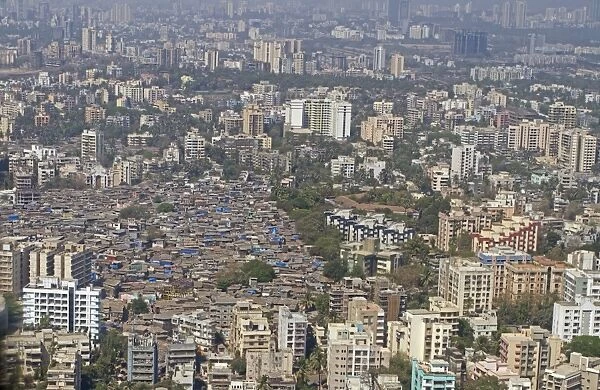Aerial view of slum areas surrounded by luxury apartments and offices, India, February