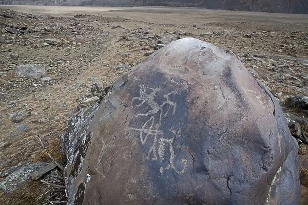 Ancient petroglyphs depicting animals and humans hunting, circa 400 A. D. High Altai, Bayan-Ulgii, Western Mongolia