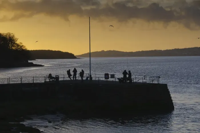 Framed Print : Anglers on pier silhouetted at sunset, River Kent, Arnside, Morecambe Bay, Cumbria, England, january