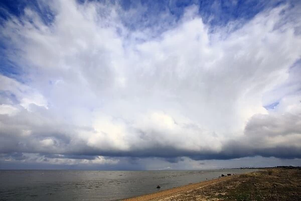 Approaching snow clouds over estuary habitat, Snettisham RSPB Reserve, The Wash, Norfolk, England, March