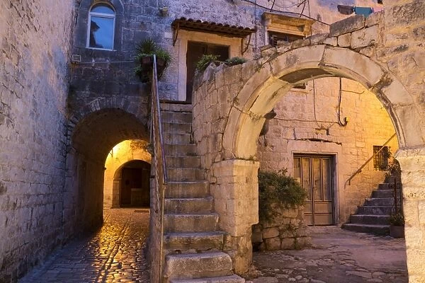 Archway and house in old town at night, Trogir, Dalmatia, Croatia, July