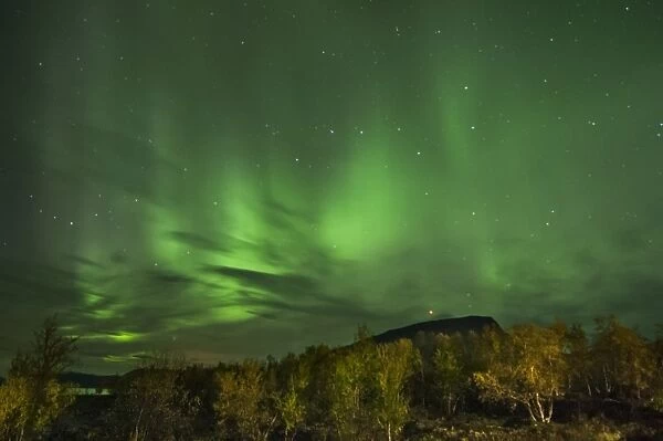 Aurora Borealis over fell at night, Saana Fell, Kilpisjarvi, Enontekio, Lapland, Finland, September