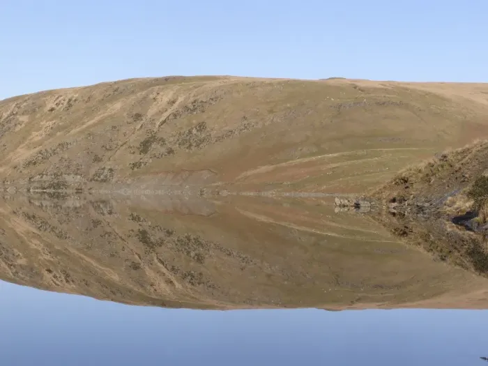 Framed Print : Banks of reservoir reflected in water, Claerwen Dam, Elan Valley, Powys, Wales, january
