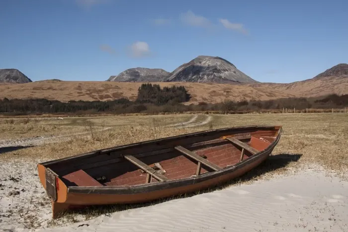 Framed Print : Beached rowing boat at Traigh na Mile beach with the Paps of Jura behind. - Isle of Jura Scotland
