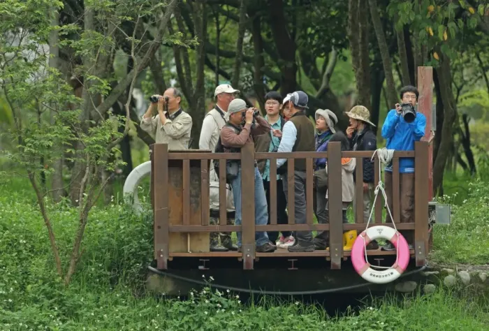 Framed Print : Birdwatchers with binoculars and camera on platform, contestants in bird race Framed Print : Birdwatchers with binoculars and camera on platform, contestants in bird race