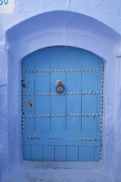 Blue door in street of city, Chefchaouen, Morocco, april