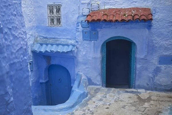 Blue doors and houses in alley of city, Chefchaouen, Morocco, april