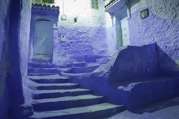 Blue doors and stairway in alley of city at night, Chefchaouen, Morocco, april