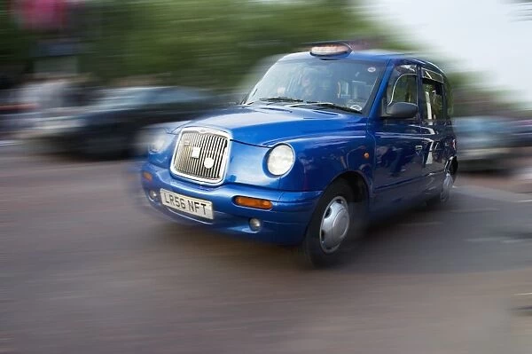 Blue taxi on city road, The Mall, City of Westminster, London, England, april