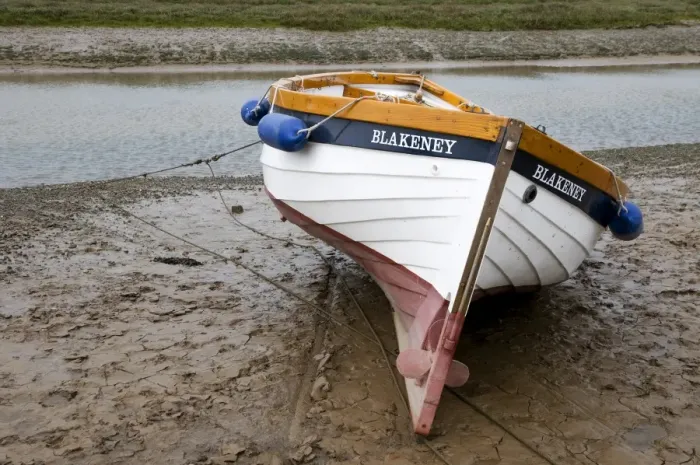 Framed Print : Boat moored on mud at edge of coastal creek, Blakeney, Norfolk, England, may Framed Print : Boat moored on mud at edge of coastal creek, Blakeney, Norfolk, England, may