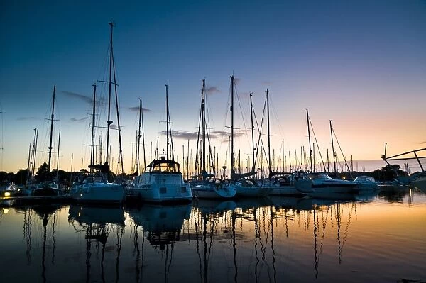 Boats moored in marina at sunset, Chichester Marina, Chichester, West Sussex, England, july