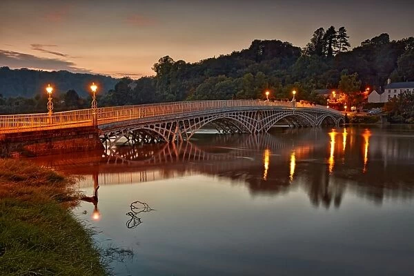 Bridge over river during high tide at dusk, Old Wye Bridge, Chepstow, River Wye, Wye Valley, Monmouthshire, Wales