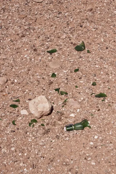 Framed Print : Broken glass bottle dumped by the side of the road, risk to wildlife and fire Framed Print : Broken glass bottle dumped by the side of the road, risk to wildlife and fire