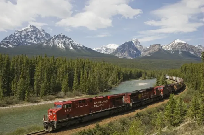 Framed Print : Canadian Pacific railway train travelling along track, with range of mountains in background, Bow Range, Morant's Curve, Banff N. P. Rocky Mountains, Alberta, Canada, june Framed Print : Canadian Pacific railway train travelling along track, with range of mountains in background, Bow Range, Morant's Curve, Banff N. P. Rocky Mountains, Alberta, Canada, june
