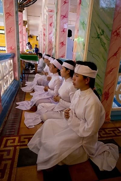 Caodaist disciples sitting on balcony during ceremony, Cao Dai temple, Tay Ninh Holy See, Tay Ninh, Tay Ninh Province