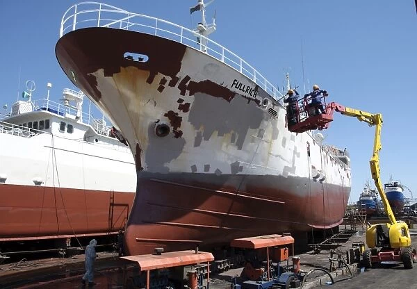 Cargo ship being repainted in dry dock, Cape Town, Western Cape, South Africa