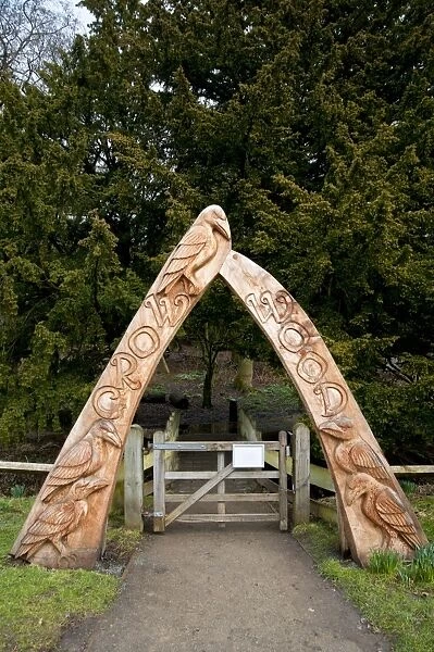 Carved wooden archway at entrance to woodland, Crow Wood, Danby, North York Moors N. P. North Yorkshire, England, March