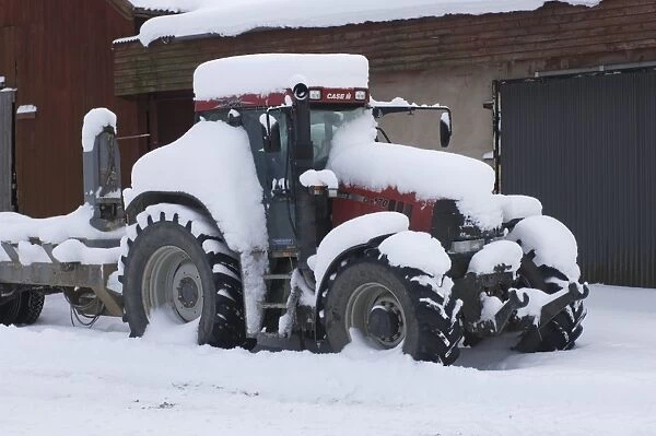 Case CVX170 tractor, covered in deep snow, Sweden, winter