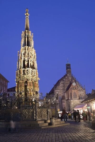 City fountain and church illuminated at night, Schoner Brunnen, Church of Our Lady, Nuremberg, Bavaria, Germany