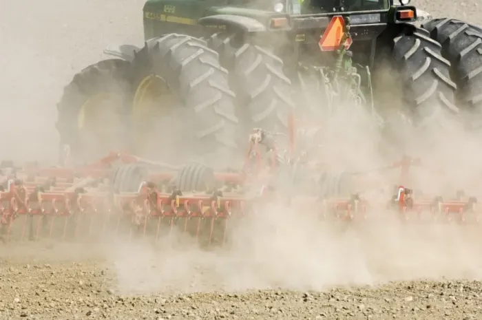 Framed Print : Close-up of tractor pulling harrows, harrowing field with wind blown dust, Sweden, spring Framed Print : Close-up of tractor pulling harrows, harrowing field with wind blown dust, Sweden, spring