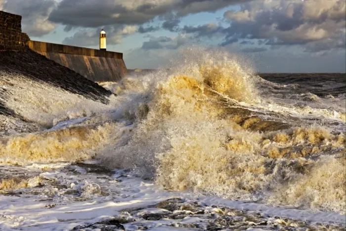 Framed Print : Coastal resort town seafront and lighthouse bombarded by waves, Porthcawl Pier, Porthcawl, Bristol Channel