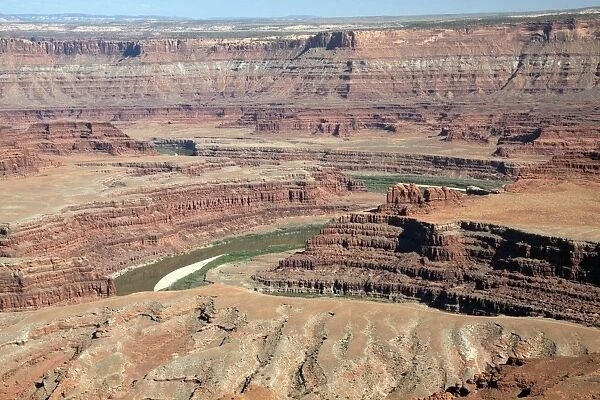 Colorado River seen here at Dead Horse Point has cut threw many layers of rock from Navajo Sandstone at the top to Rico