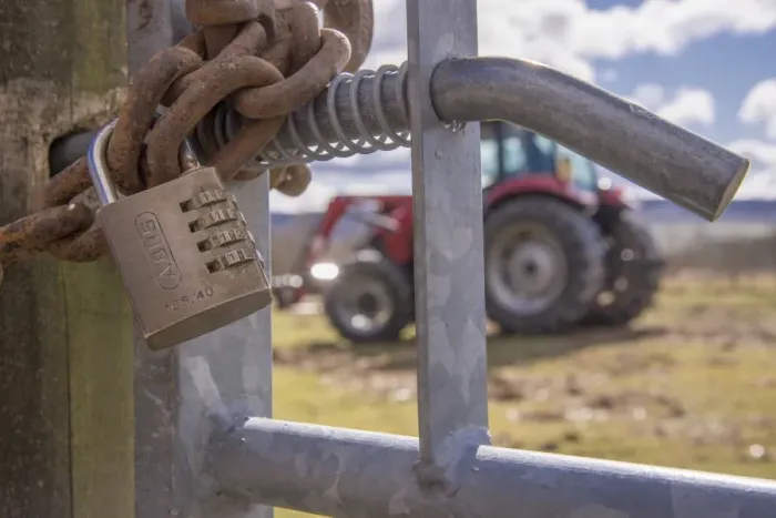 Framed Print : Combination lock and heavy chain on farm gate, with tractor in background, Lancashire, England, March Framed Print : Combination lock and heavy chain on farm gate, with tractor in background, Lancashire, England, March