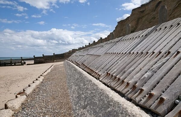 Concrete and timber sea defences on beach, West Runton, Norfolk, England, August