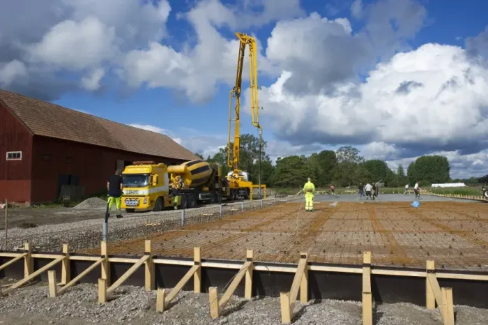 Framed Print : Construction work on farm building for loose housing, concrete mixer trunk with concrete poured onto reinforcing bars Framed Print : Construction work on farm building for loose housing, concrete mixer trunk with concrete poured onto reinforcing bars